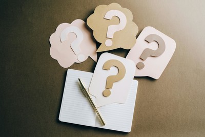 Notebook, pen and question marks
